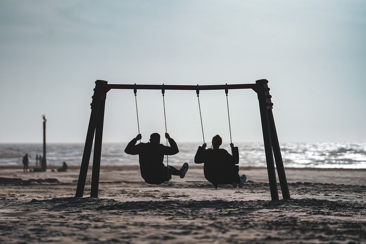 beach swing couple sun north sea 7546731